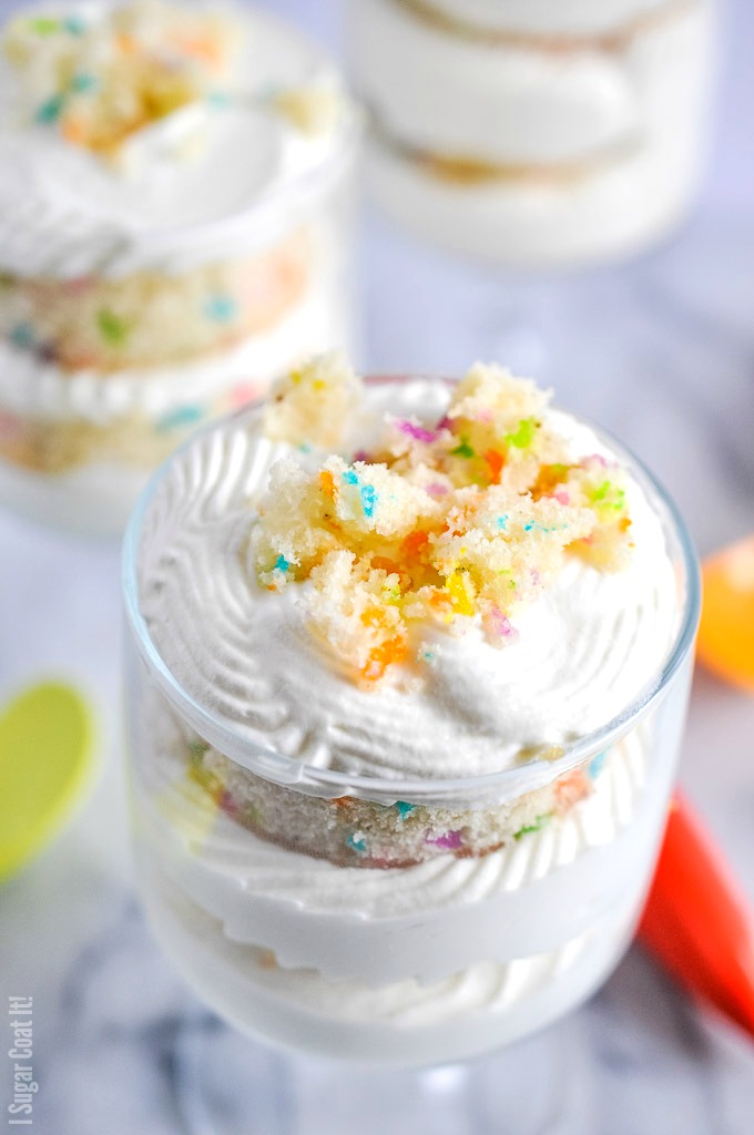 Funfetti White Chocolate Mousse Trifle are layers of funfetti vanilla cake, pineapple curd and an easy 2-ingredient white chocolate mousse, stacked in single-serve sized trifles.