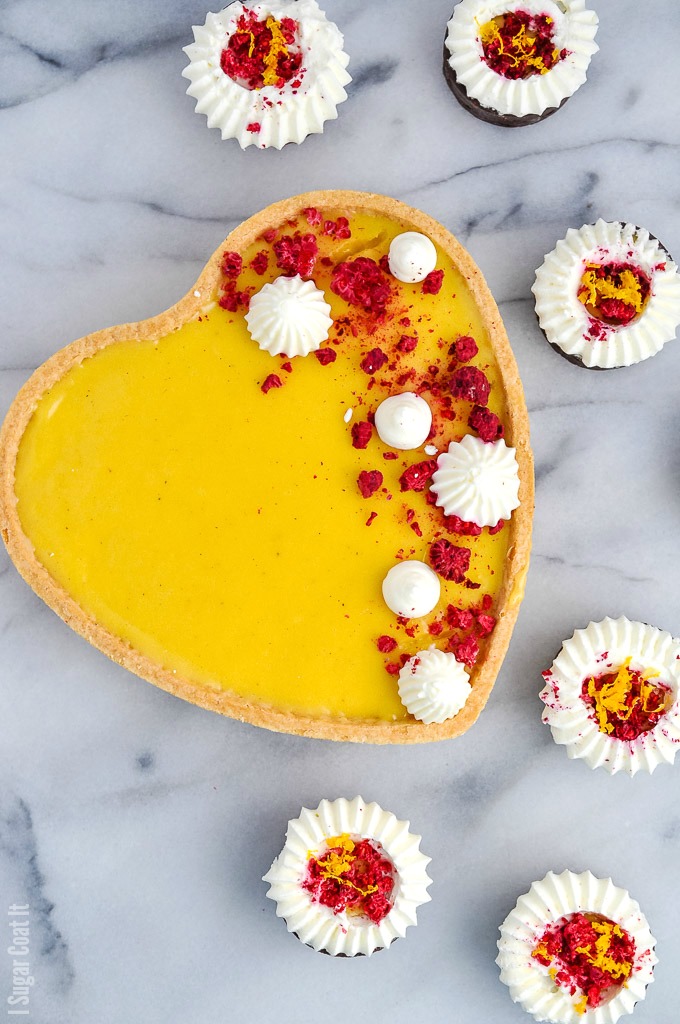 Luscious Yuzu White Chocolate Tart is flavourful, fragrant yuzu lemon and silky white chocolate piped into sweet pastry and topped with freeze-dried raspberry and whipped cream.