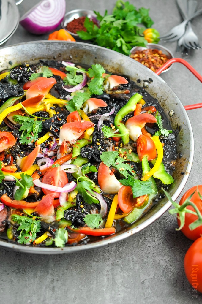 Seafood Paella Noir with Arctic Surf Clams, baby octopus, shrimps, Thai purple rice and a colourful array of vegetables and spices.